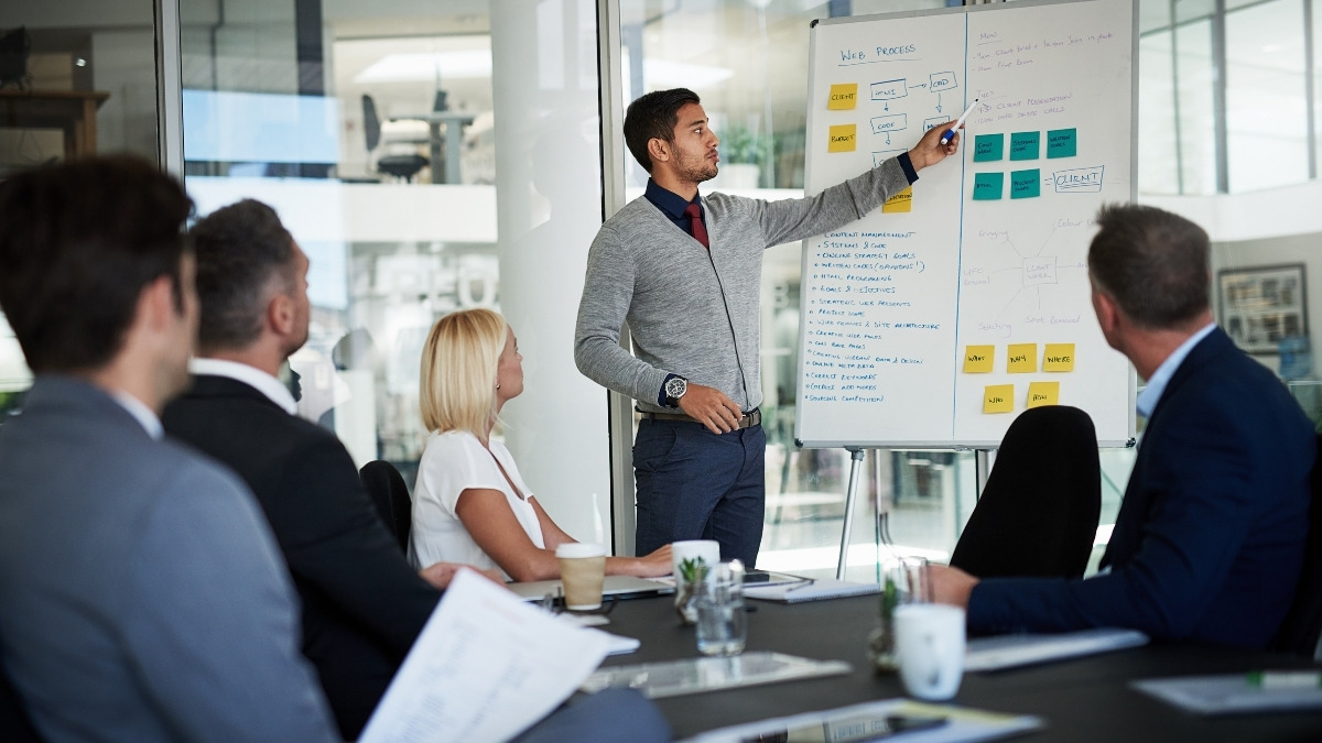 business meeting in a modern, glass-walled conference room